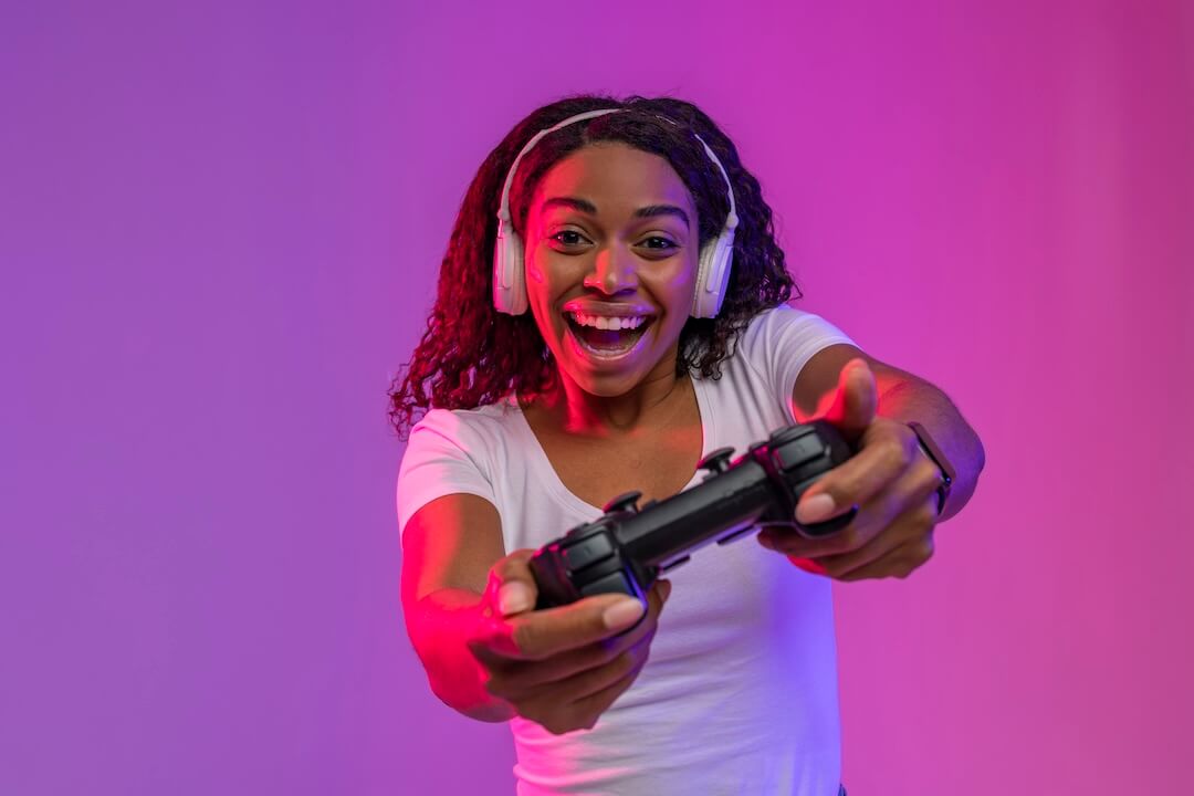 excited young woman with joystick playing video game