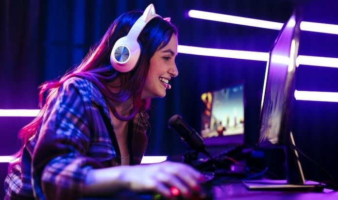 Girl with headphones on a desktop PC