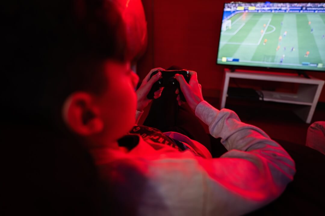 Boy playing football game on controller
